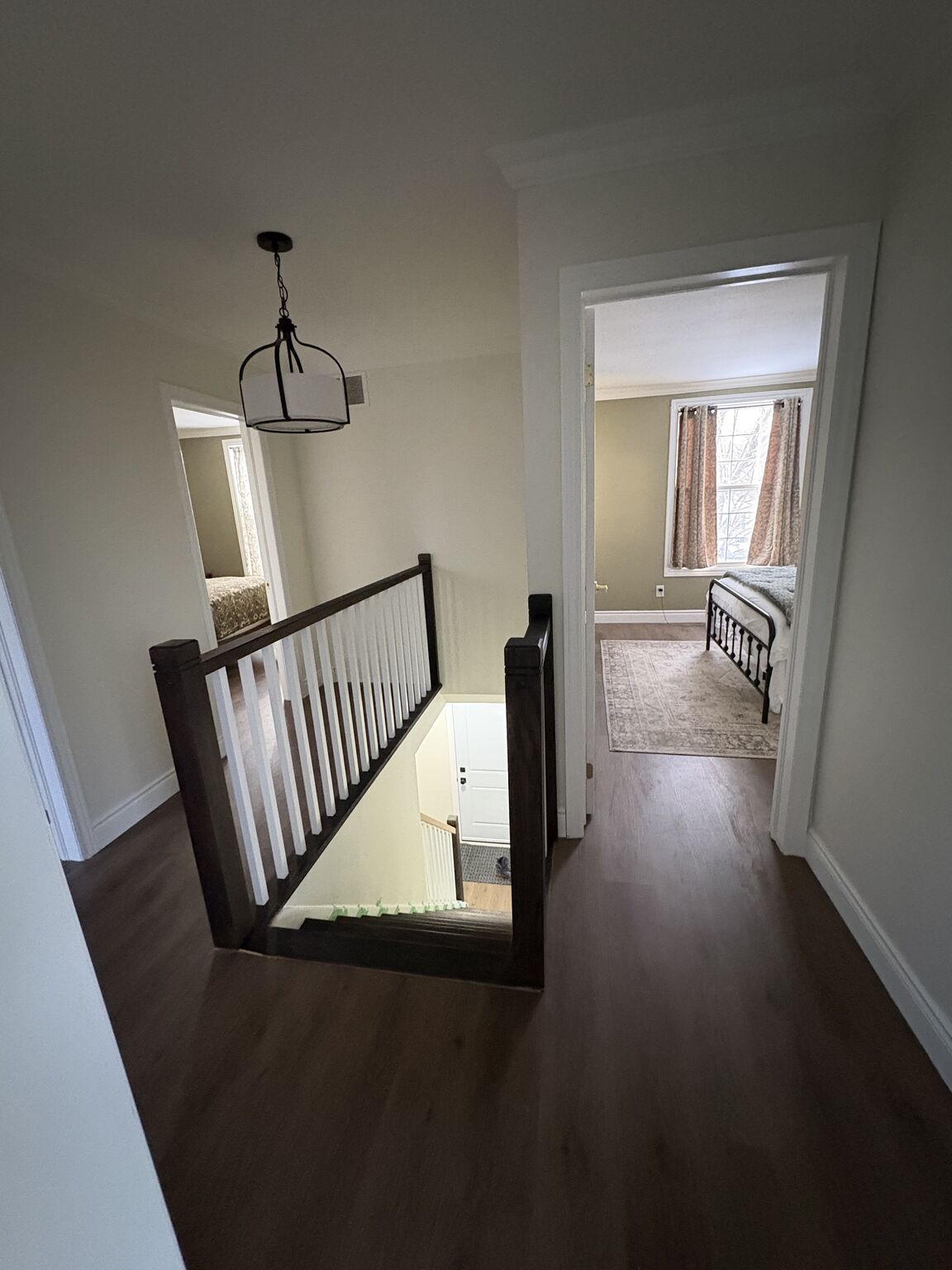 Upper landing hallway with custom railing and hardwood floors by Bulldawgs Construction Cambridge