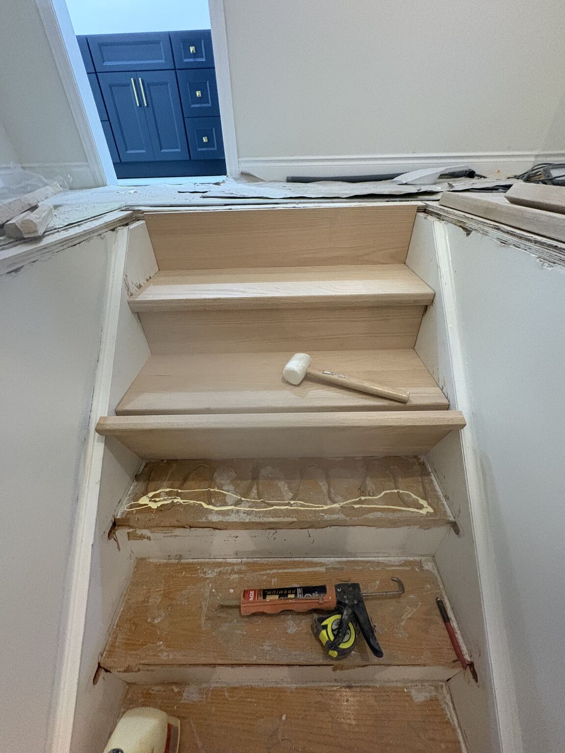 Staircase before renovation - raw subfloor and unfinished treads in Cambridge Ontario home
